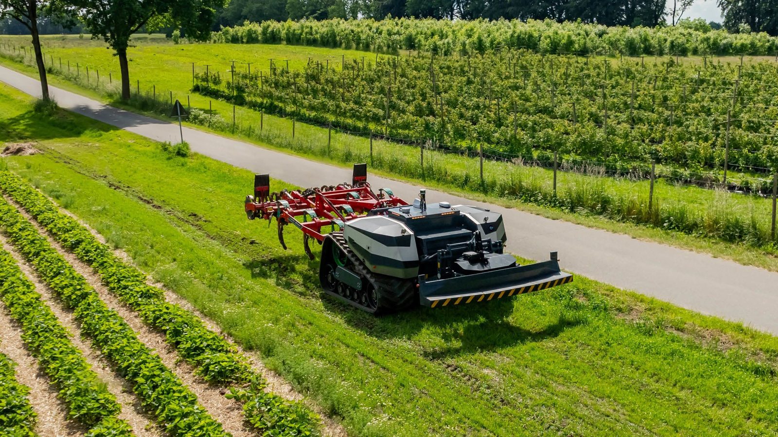 Agricultural machinery working a field during the hay harvest