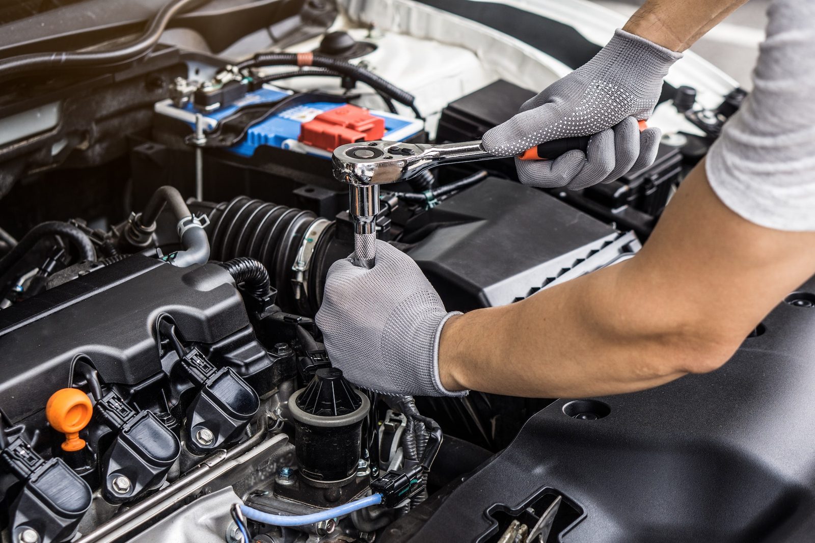 Technician working on a vehicle engine