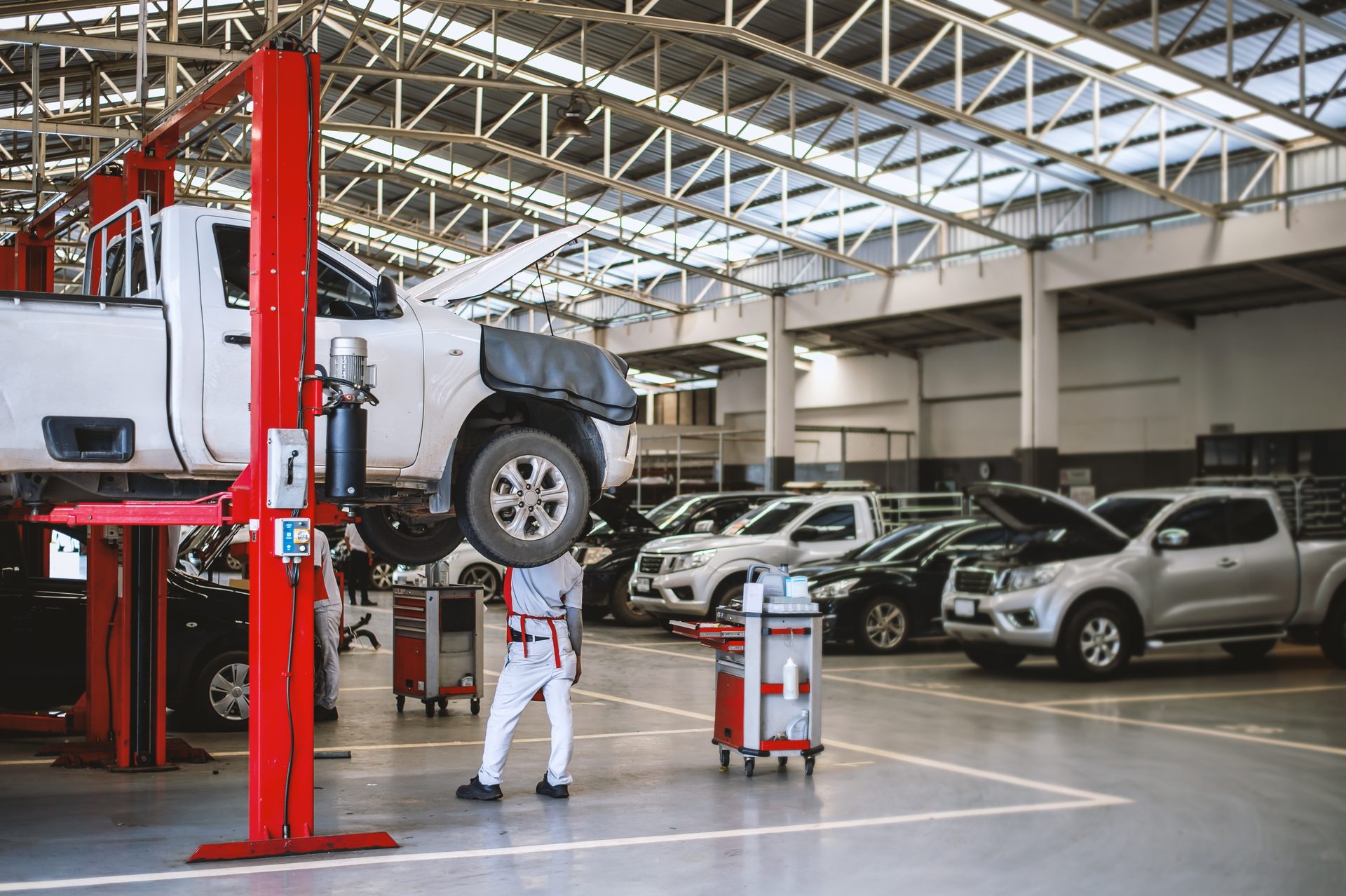 Vehicle raised on a two-post lift in a professional workshop
