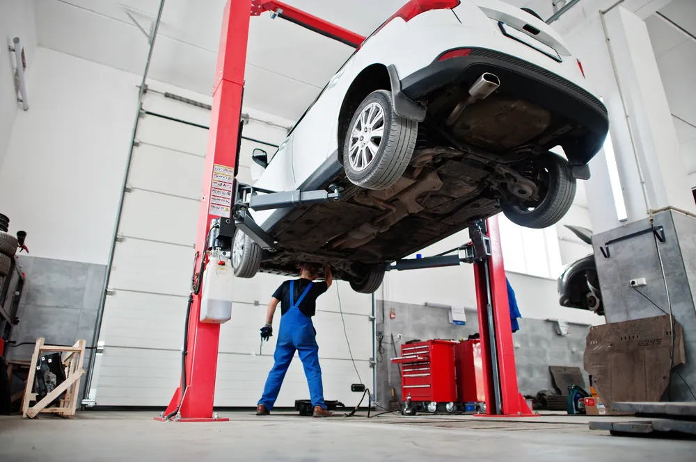 Vehicle raised on a two-post garage lift
